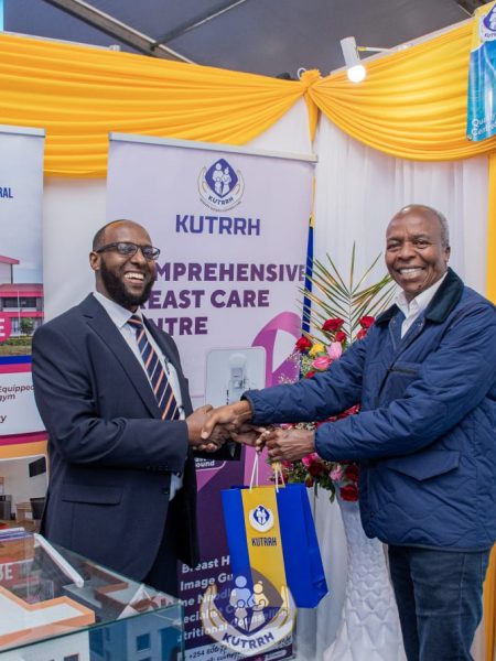 KUTRRH’s CEO, Ahmed Dagane(left) hosts the NHIF Board Chairman, Eng. Michael Kamau(right) at the KUTRRH stand during the 2023 Devolution Conference.